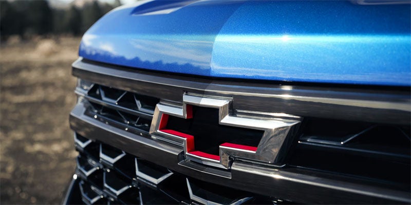 Close-up of the iconic Chevy emblem on the front of the 2026 Chevrolet Silverado 1500 in Eureka, IL, representing the trusted Chevrolet brand.
